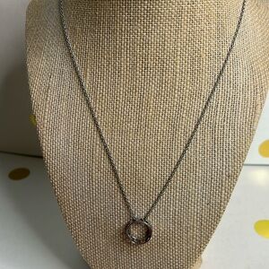 Rachel silver necklace with circle charm featuring punched out hearts